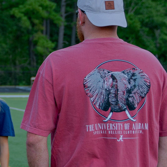Group of people on a sports field wearing branded t-shirts.
